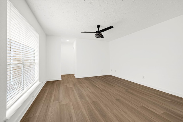 711 Charidges Dr, Houston, TX 77034 - unfurnished room featuring wood finished floors, a ceiling fan, and a textured ceiling