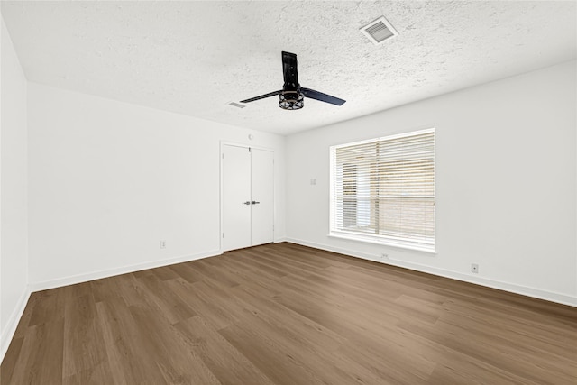 711 Charidges Dr, Houston, TX 77034 - spare room featuring dark wood finished floors, a ceiling fan, and a textured ceiling