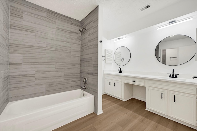 711 Charidges Dr, Houston, TX 77034 - full bath with double vanity, shower / washtub combination, and wood finished floors