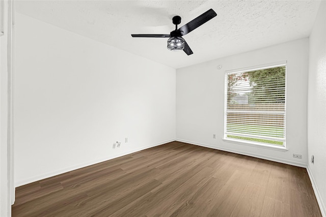 711 Charidges Dr, Houston, TX 77034 - unfurnished room featuring dark wood-style flooring and a ceiling fan