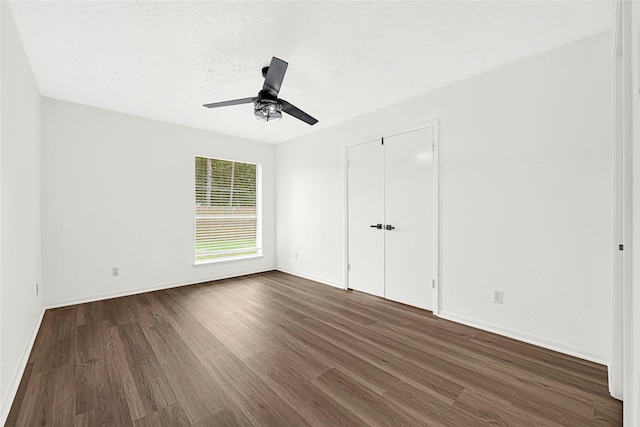 711 Charidges Dr, Houston, TX 77034 - unfurnished bedroom with dark wood finished floors, ceiling fan, and a closet