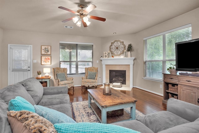 1900 Pagemill Ln, Conroe, TX 77304 - living area featuring healthy amount of natural light, a fireplace, a ceiling fan, and wood finished floors