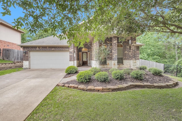 1900 Pagemill Ln, Conroe, TX 77304 - view of front facade featuring an attached garage, brick siding, concrete driveway, roof with shingles, and stone siding