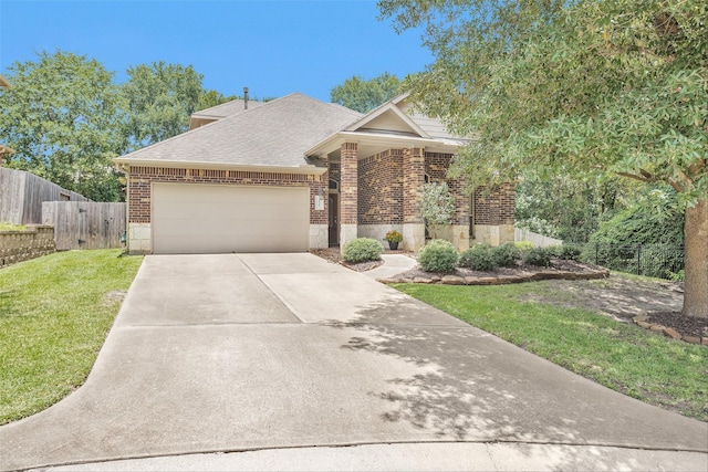 1900 Pagemill Ln, Conroe, TX 77304 - view of front of house featuring brick siding, a garage, concrete driveway, and roof with shingles