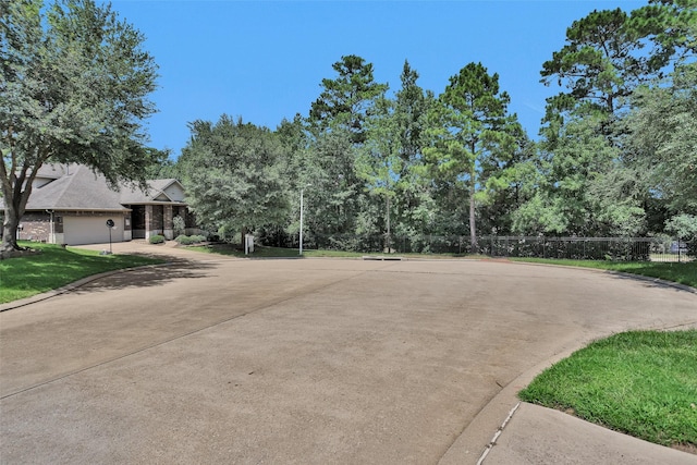 1900 Pagemill Ln, Conroe, TX 77304 - view of concrete street featuring curbs and view of wooded area