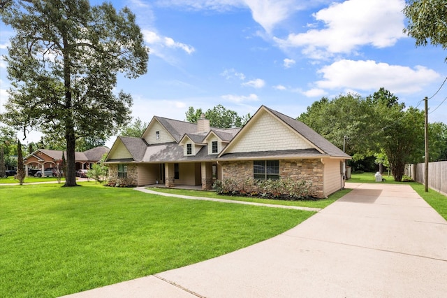 14607 Dawn Mist Ct, Magnolia, TX 77354 - view of front of home featuring stone siding, driveway, and a chimney