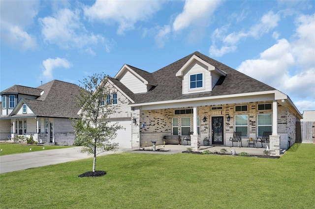 14315 Pecos Ln, Baytown, TX 77523 - view of front of home featuring concrete driveway, brick siding, a front lawn, covered porch, and roof with shingles