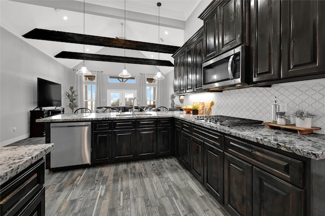 14315 Pecos Ln, Baytown, TX 77523 - kitchen featuring stainless steel appliances, decorative backsplash, wood finished floors, ornamental molding, and light stone counters