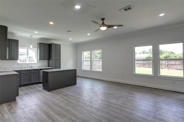 5774 Gineridge Dr, Houston, TX 77053 - kitchen with ornamental molding, a center island, wood finished floors, a ceiling fan, and recessed lighting