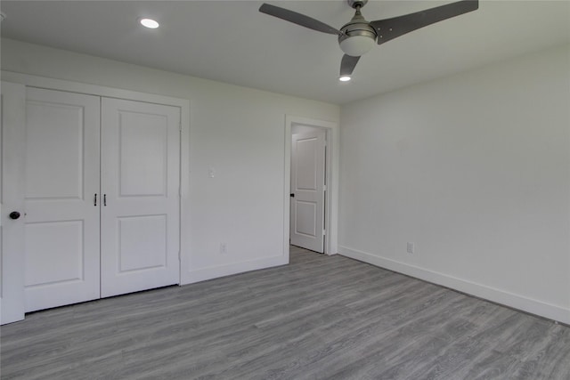5774 Gineridge Dr, Houston, TX 77053 - unfurnished bedroom featuring a closet, wood finished floors, a ceiling fan, and recessed lighting