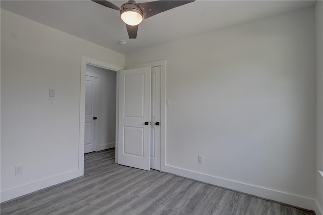 5774 Gineridge Dr, Houston, TX 77053 - empty room with light wood-style flooring, a smoke detector, and ceiling fan