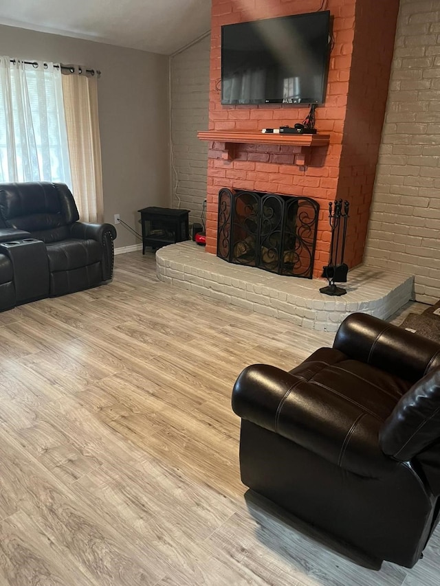 13706 Towneway Dr, Sugar Land, TX 77498 - living area with a brick fireplace, wood finished floors, and vaulted ceiling