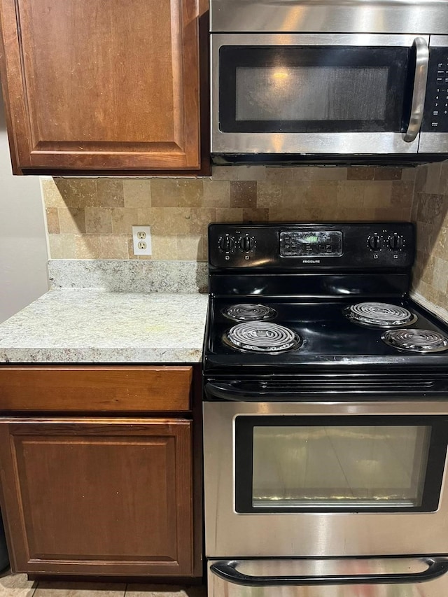 13706 Towneway Dr, Sugar Land, TX 77498 - kitchen with appliances with stainless steel finishes, decorative backsplash, and light countertops
