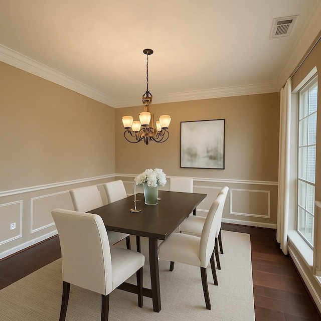 2214 Jurgensen Ln, Sugar Land, TX 77479 - dining space with a chandelier, ornamental molding, dark wood-type flooring, a decorative wall, and wainscoting
