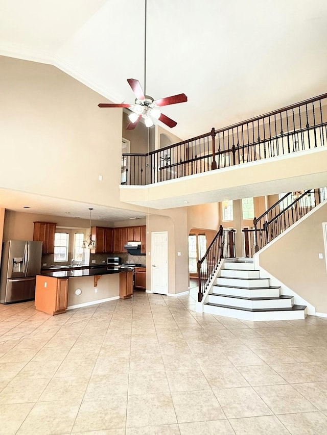 2214 Jurgensen Ln, Sugar Land, TX 77479 - unfurnished living room featuring light tile patterned flooring, high vaulted ceiling, a ceiling fan, and stairway