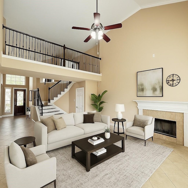 2214 Jurgensen Ln, Sugar Land, TX 77479 - living room with high vaulted ceiling, tile patterned floors, a ceiling fan, a tiled fireplace, and stairway