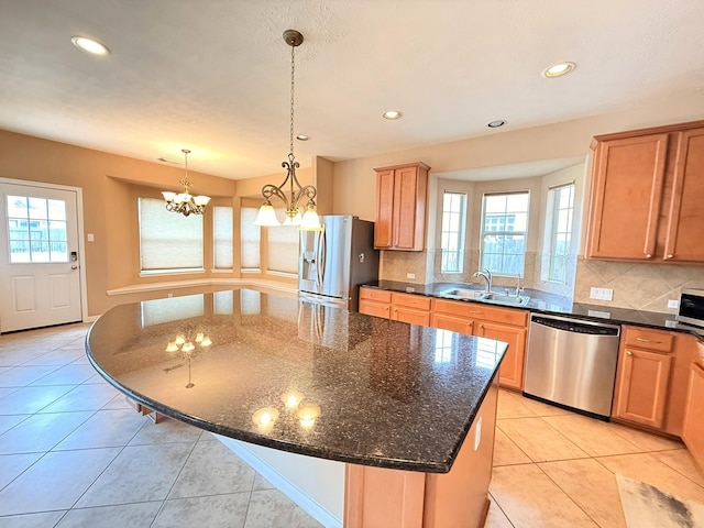 2214 Jurgensen Ln, Sugar Land, TX 77479 - kitchen with appliances with stainless steel finishes, light tile patterned floors, backsplash, a center island, and recessed lighting