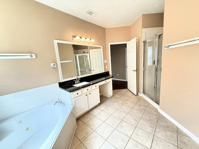 2214 Jurgensen Ln, Sugar Land, TX 77479 - bathroom with vanity, tile patterned floors, a shower stall, and a tub with jets