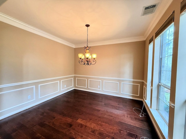 2214 Jurgensen Ln, Sugar Land, TX 77479 - unfurnished dining area featuring dark wood-style floors, ornamental molding, a chandelier, a wainscoted wall, and a decorative wall
