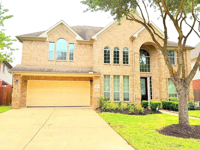 2214 Jurgensen Ln, Sugar Land, TX 77479 - view of front of property with driveway, an attached garage, brick siding, and roof with shingles