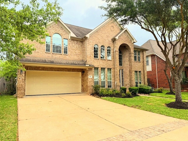 2214 Jurgensen Ln, Sugar Land, TX 77479 - traditional-style house featuring a garage, a front yard, brick siding, and concrete driveway