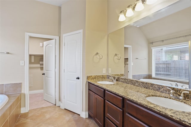 21902 Juniper Wood Ln, Richmond, TX 77469 - full bathroom featuring a garden tub, double vanity, lofted ceiling, tile patterned floors, and a spacious closet