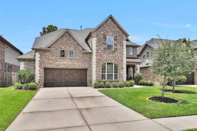 31304 New Forest Park Ln, Spring, TX 77386 - french country style house featuring brick siding, driveway, a front yard, and a shingled roof