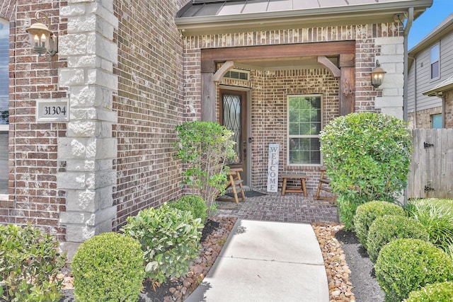 31304 New Forest Park Ln, Spring, TX 77386 - entrance to property with brick siding, a standing seam roof, and a metal roof