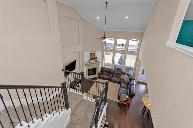 31304 New Forest Park Ln, Spring, TX 77386 - staircase featuring ornamental molding, high vaulted ceiling, wood finished floors, a ceiling fan, and a fireplace