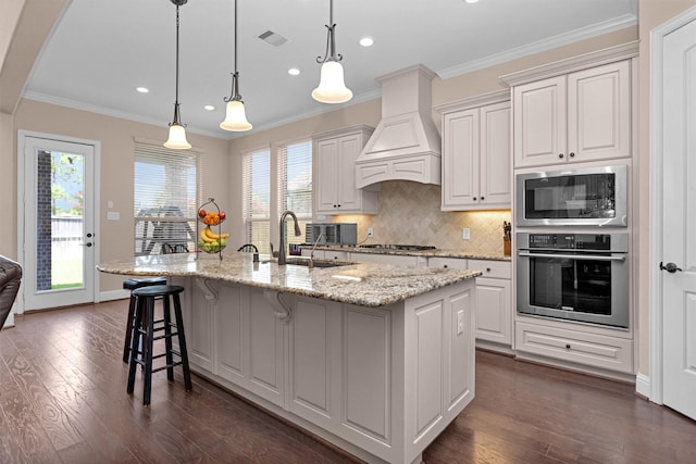 31304 New Forest Park Ln, Spring, TX 77386 - kitchen with stainless steel appliances, dark wood-style floors, decorative backsplash, a kitchen bar, and recessed lighting