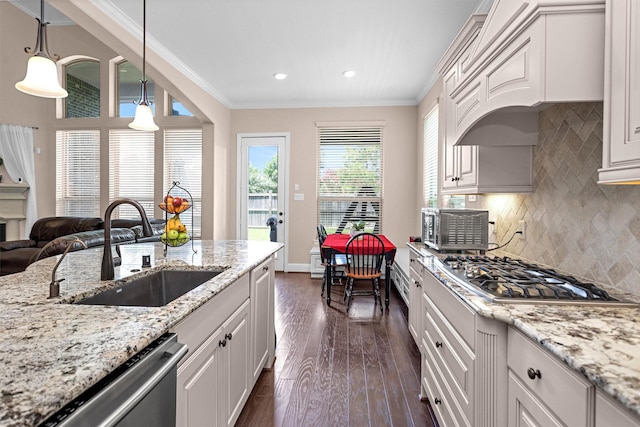 31304 New Forest Park Ln, Spring, TX 77386 - kitchen with dark wood-style floors, appliances with stainless steel finishes, ornamental molding, backsplash, and white cabinetry