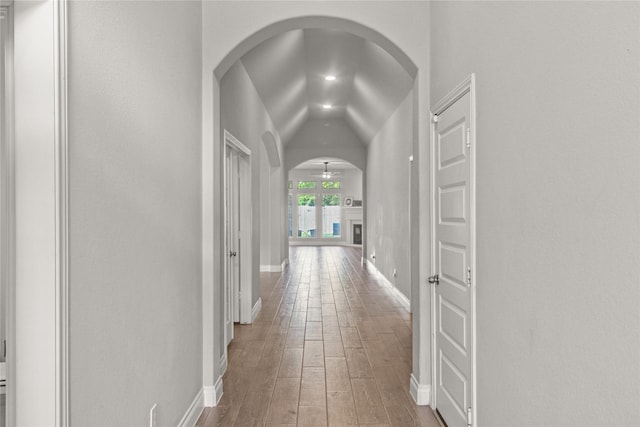 15 Eden Hollow Ln, Richmond, TX 77406 - hallway with arched walkways, hardwood / wood-style floors, and vaulted ceiling
