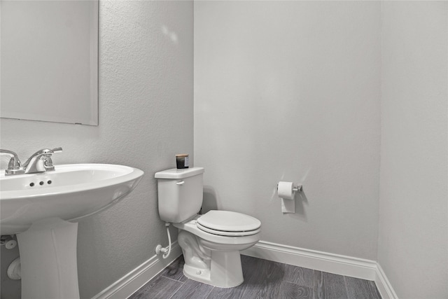 15 Eden Hollow Ln, Richmond, TX 77406 - half bathroom with baseboards and wood finished floors