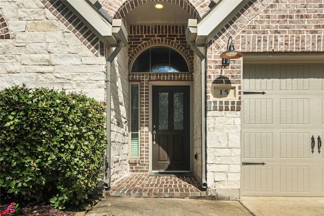 15 Eden Hollow Ln, Richmond, TX 77406 - doorway to property featuring a garage, stone siding, and brick siding