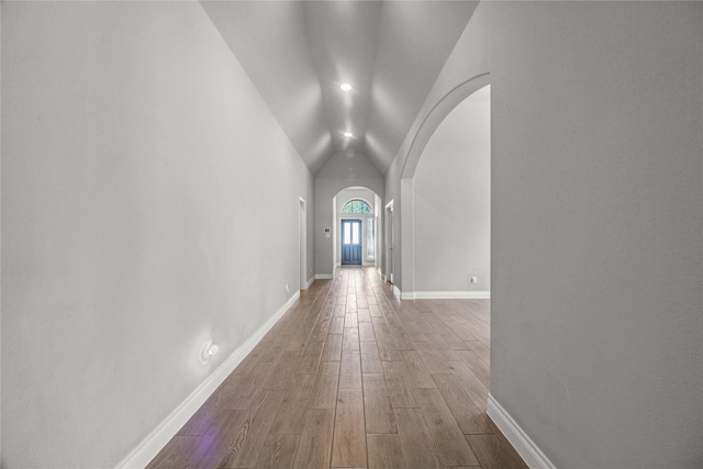 15 Eden Hollow Ln, Richmond, TX 77406 - corridor featuring arched walkways, wood finished floors, and lofted ceiling