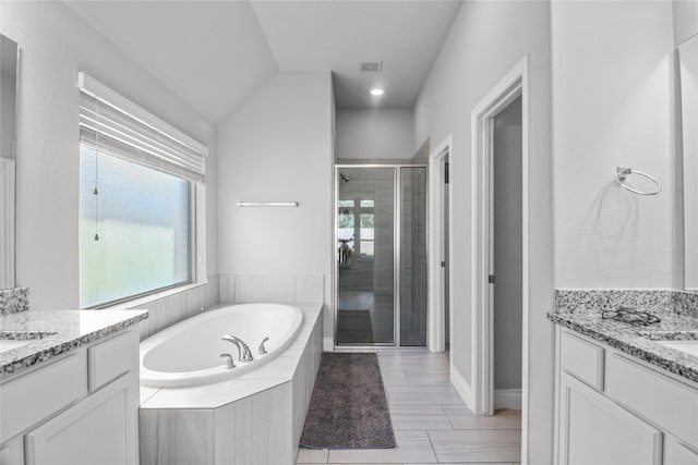 15 Eden Hollow Ln, Richmond, TX 77406 - full bathroom with two vanities, a stall shower, and a garden tub