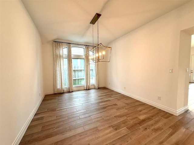 9402 Orchard Trl, Missouri City, TX 77459 - unfurnished dining area with wood finished floors and a chandelier
