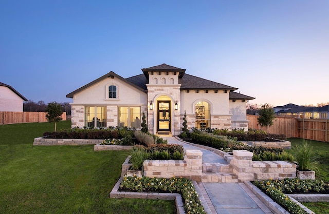 9402 Orchard Trl, Missouri City, TX 77459 - mediterranean / spanish-style house with stone siding, stucco siding, and roof with shingles