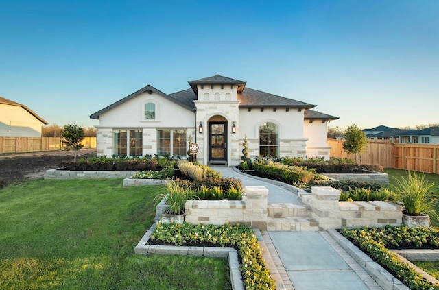 9402 Orchard Trl, Missouri City, TX 77459 - mediterranean / spanish house featuring stucco siding, stone siding, and roof with shingles