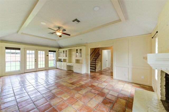 17522 Sorrel Ridge Dr, Spring, TX 77388 - unfurnished living room with healthy amount of natural light, a tray ceiling, a ceiling fan, stairs, and a decorative wall