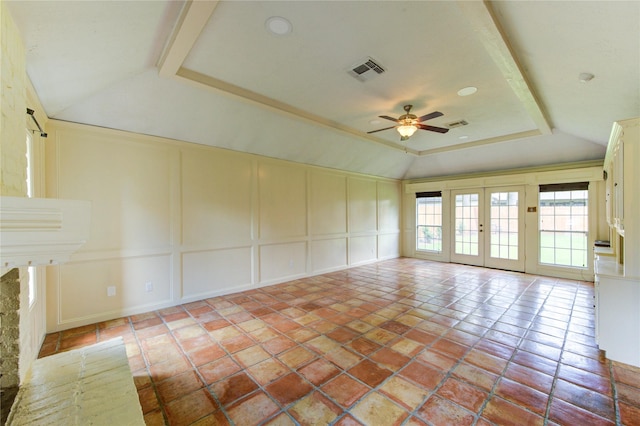 17522 Sorrel Ridge Dr, Spring, TX 77388 - unfurnished living room with vaulted ceiling, a decorative wall, ceiling fan, french doors, and a raised ceiling