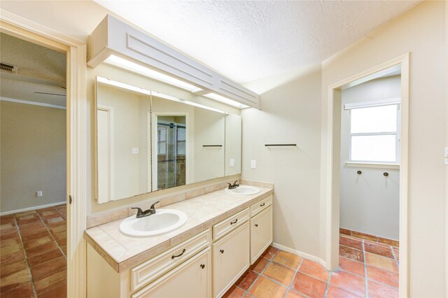 17522 Sorrel Ridge Dr, Spring, TX 77388 - full bathroom featuring double vanity and a textured ceiling