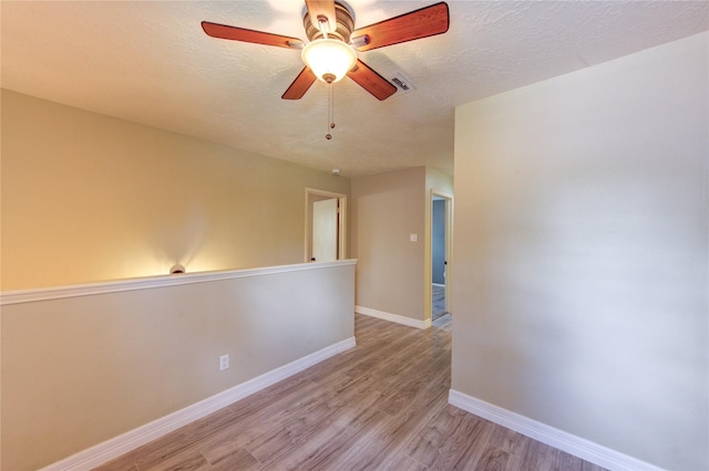 17522 Sorrel Ridge Dr, Spring, TX 77388 - unfurnished room with light wood-style floors, a ceiling fan, and a textured ceiling