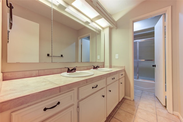 17522 Sorrel Ridge Dr, Spring, TX 77388 - full bathroom with double vanity, tile patterned floors, and bath / shower combo with glass door