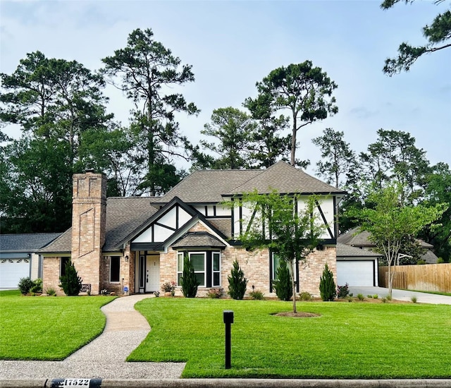 17522 Sorrel Ridge Dr, Spring, TX 77388 - tudor home with driveway, a chimney, a garage, a shingled roof, and brick siding