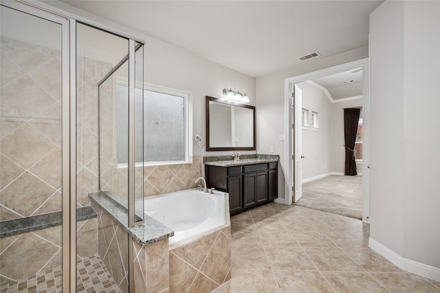 5227 Birch Falls Ln, Sugar Land, TX 77479 - bathroom featuring a garden tub, vanity, a shower stall, tile patterned flooring, and ornamental molding