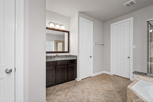 5227 Birch Falls Ln, Sugar Land, TX 77479 - bathroom featuring vanity and a garden tub
