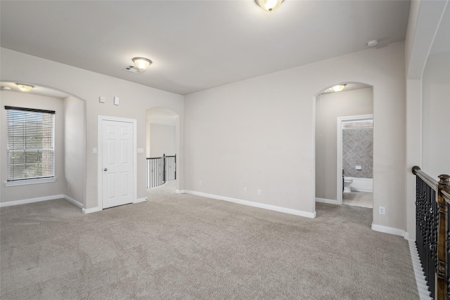 5227 Birch Falls Ln, Sugar Land, TX 77479 - carpeted empty room featuring arched walkways and a smoke detector