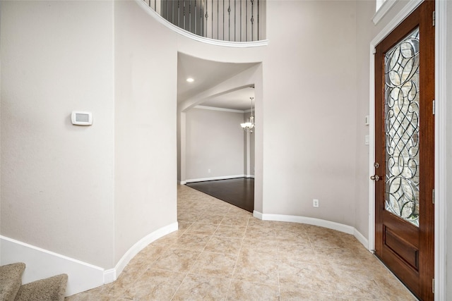 5227 Birch Falls Ln, Sugar Land, TX 77479 - tiled foyer entrance with a chandelier, a high ceiling, arched walkways, and stairs