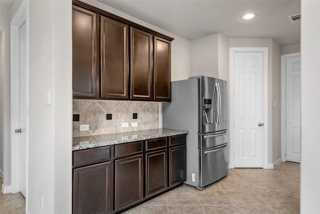5227 Birch Falls Ln, Sugar Land, TX 77479 - kitchen featuring stainless steel refrigerator with ice dispenser, dark brown cabinetry, recessed lighting, light stone countertops, and backsplash